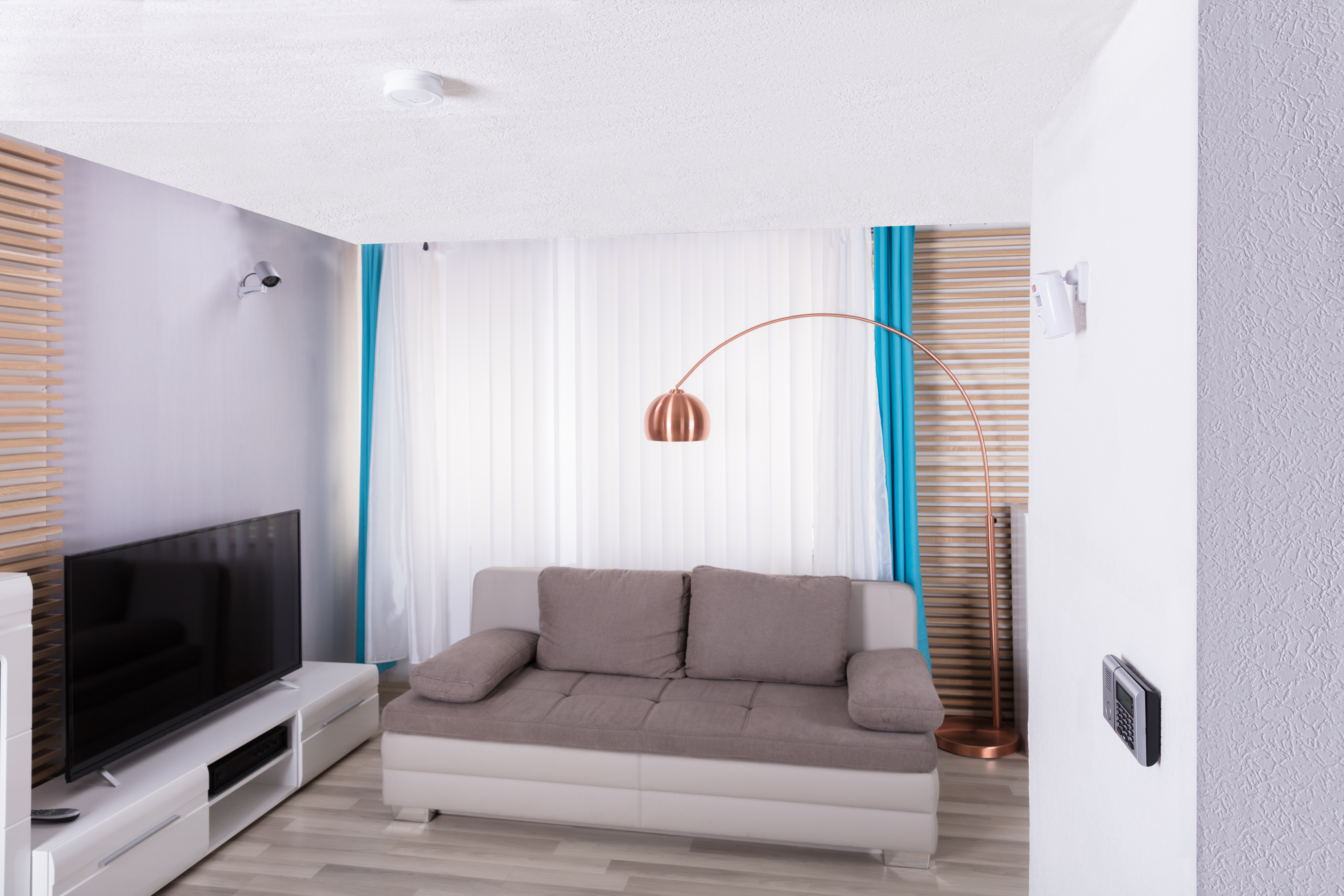 An image of a living room with a smoke alarm on the ceiling.