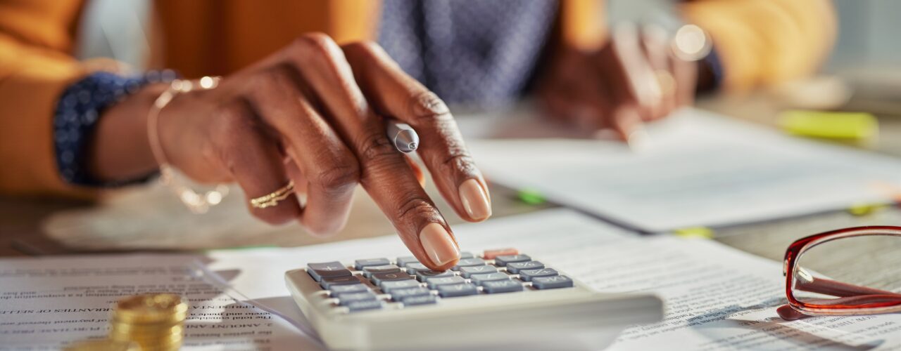 An image of a woman pressing a calculator and carrying out credit checks for renters.